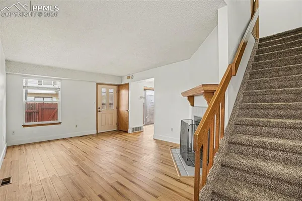a view of an entryway with wooden floor