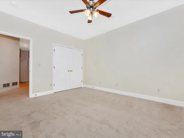 a view of a patio with table and chairs under an umbrella