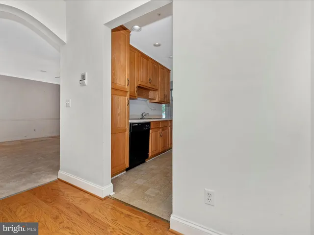 a kitchen with stainless steel appliances granite countertop a sink and a refrigerator