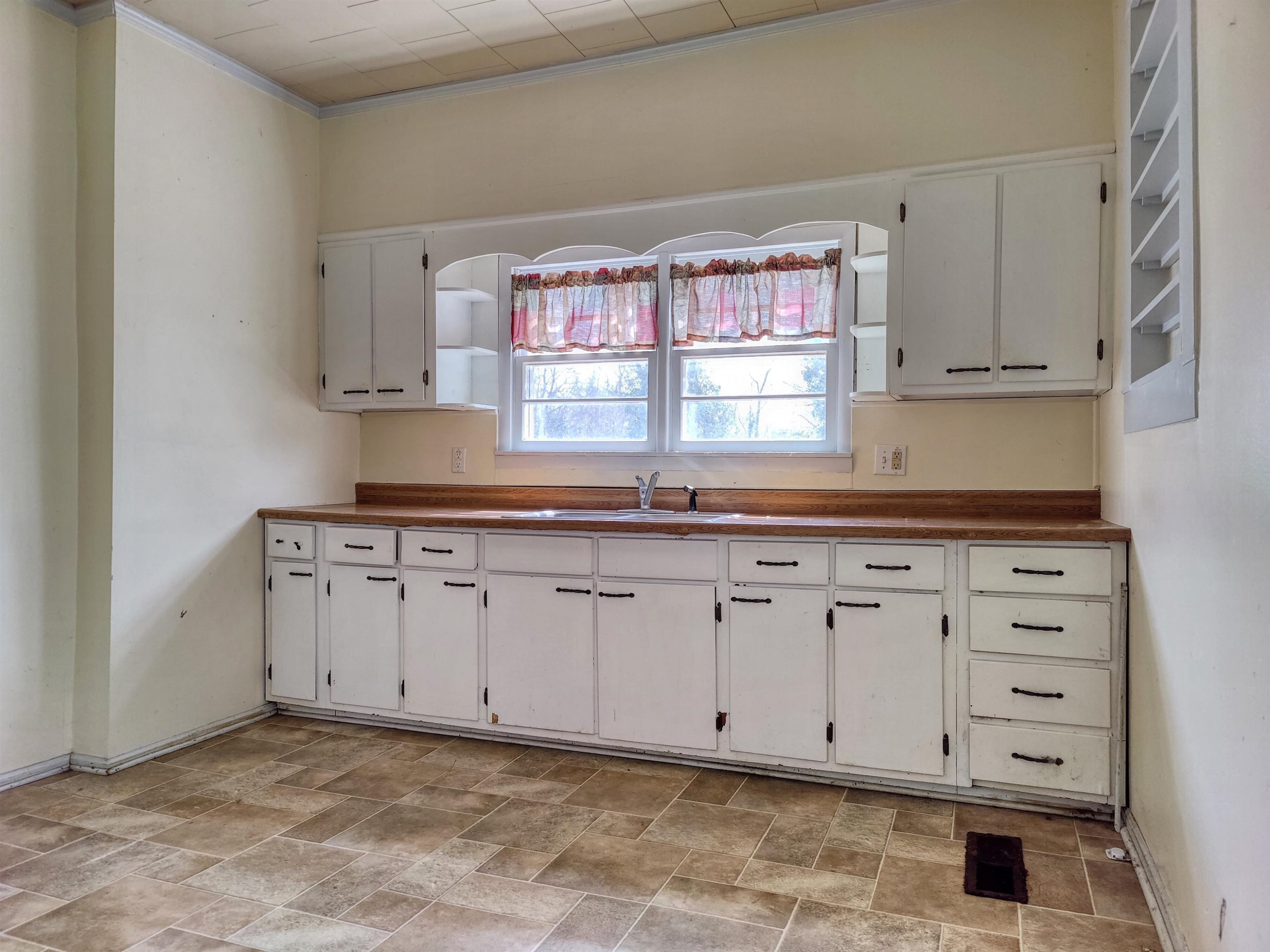 115 Walnut Lane McKenzie, TN 38201 - Photo 11 of 16 a kitchen with granite countertop white cabinets and window