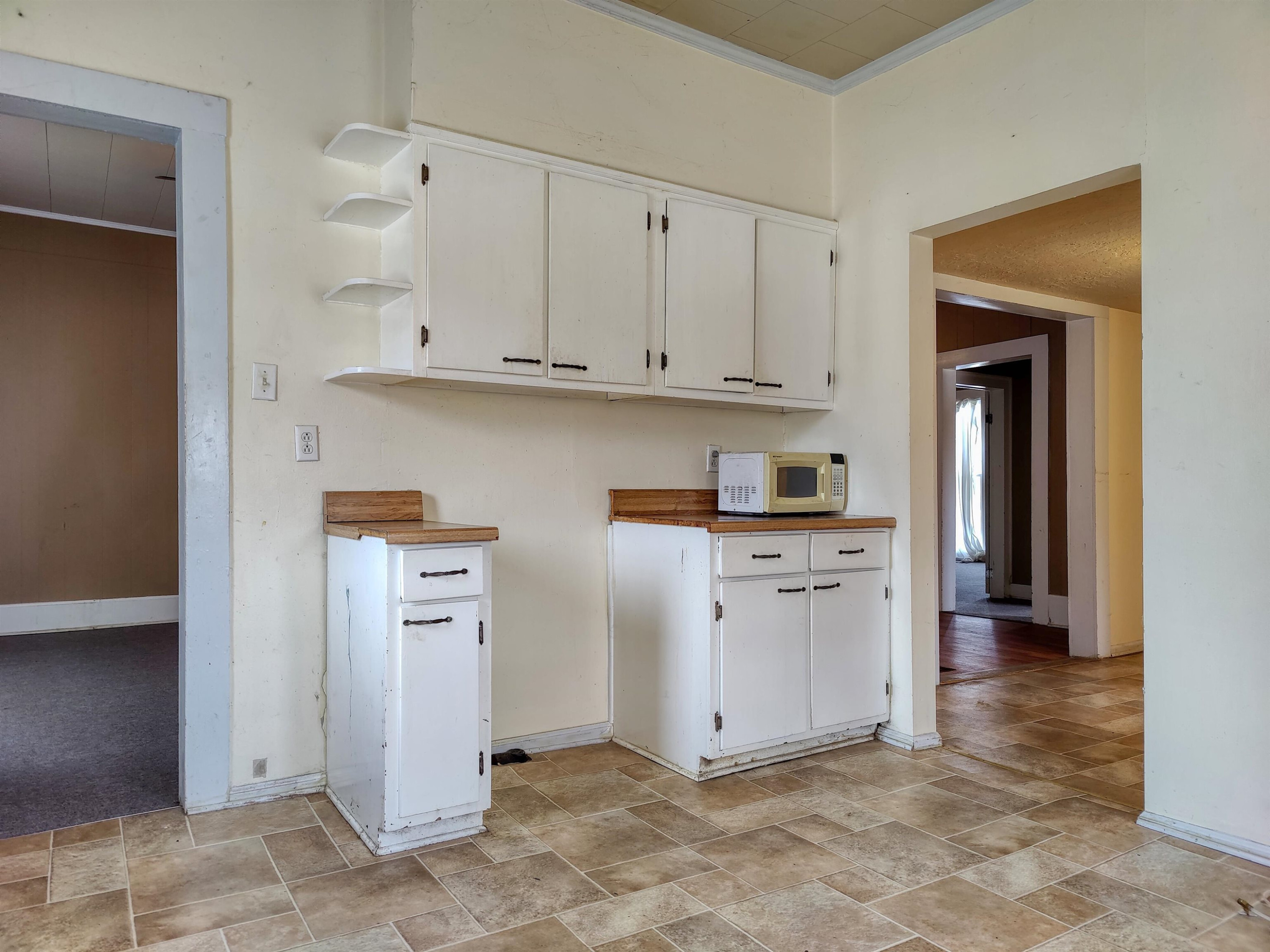 115 Walnut Lane McKenzie, TN 38201 - Photo 12 of 16 a kitchen with white cabinets and a refrigerator