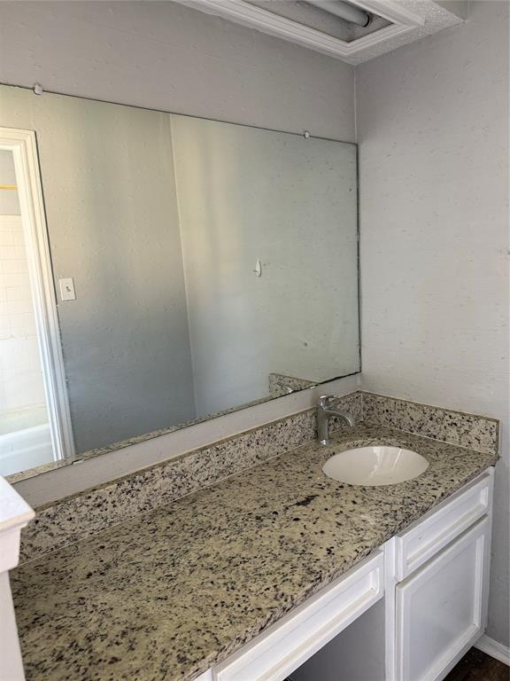 2604 Quail Valley Irving, TX 75060 - Photo 19 of 25 a bathroom with a granite countertop sink and a mirror