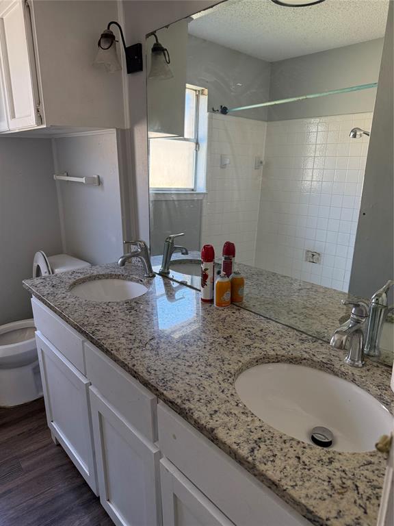 2604 Quail Valley Irving, TX 75060 - Photo 20 of 25 a bathroom with a granite countertop sink and a mirror
