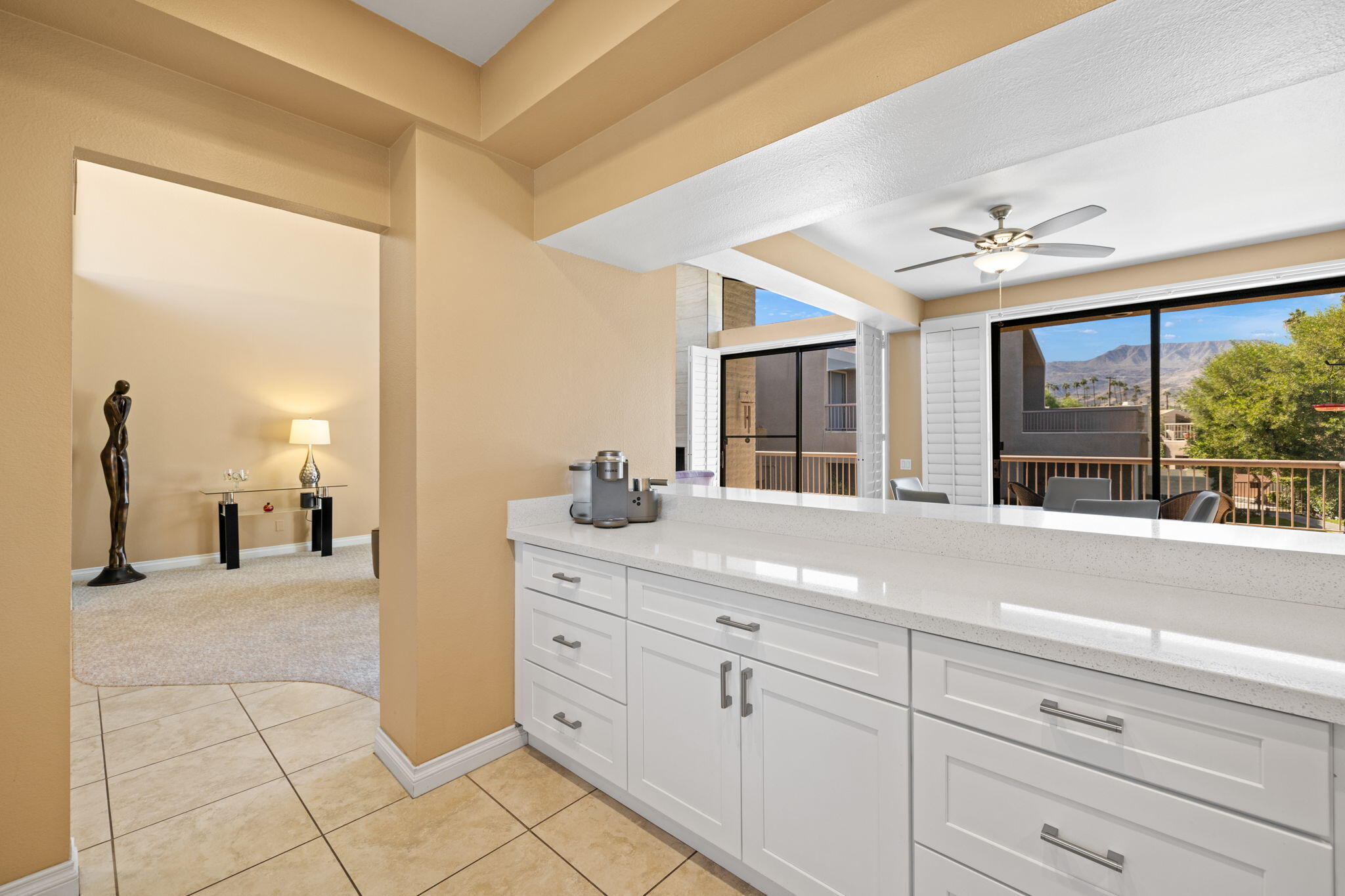 45775 Juniper Circle, Unit 616A Palm Desert, CA 92260 - Photo 11 of 35 a spacious bathroom with a granite countertop sink and a mirror