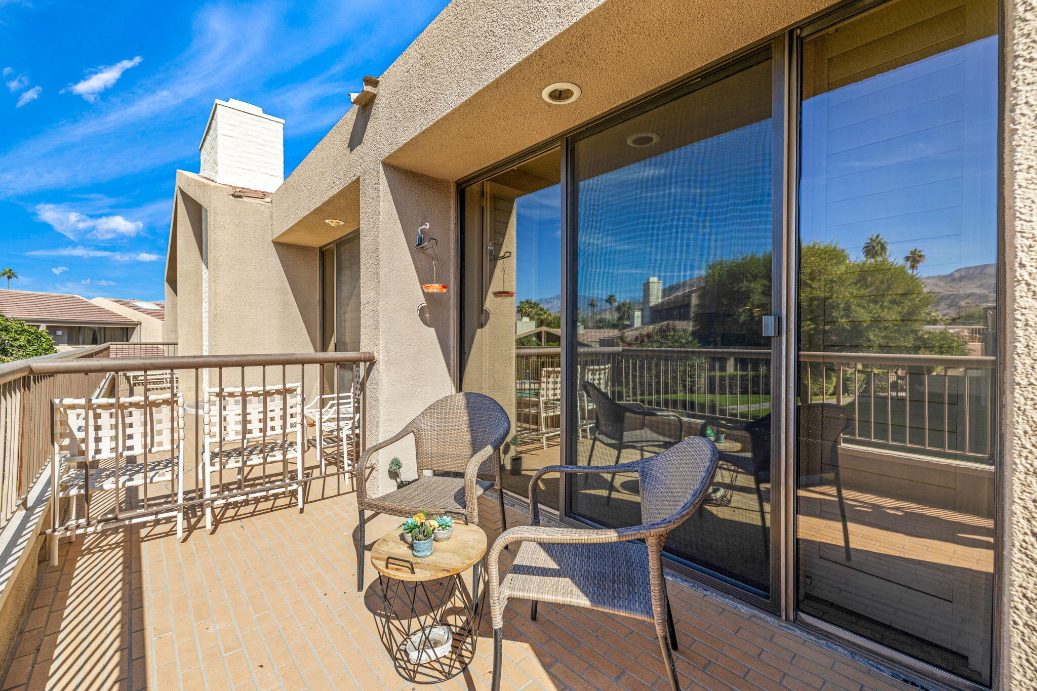45775 Juniper Circle, Unit 616A Palm Desert, CA 92260 - Photo 13 of 35 a view of a balcony with chairs and wooden floor