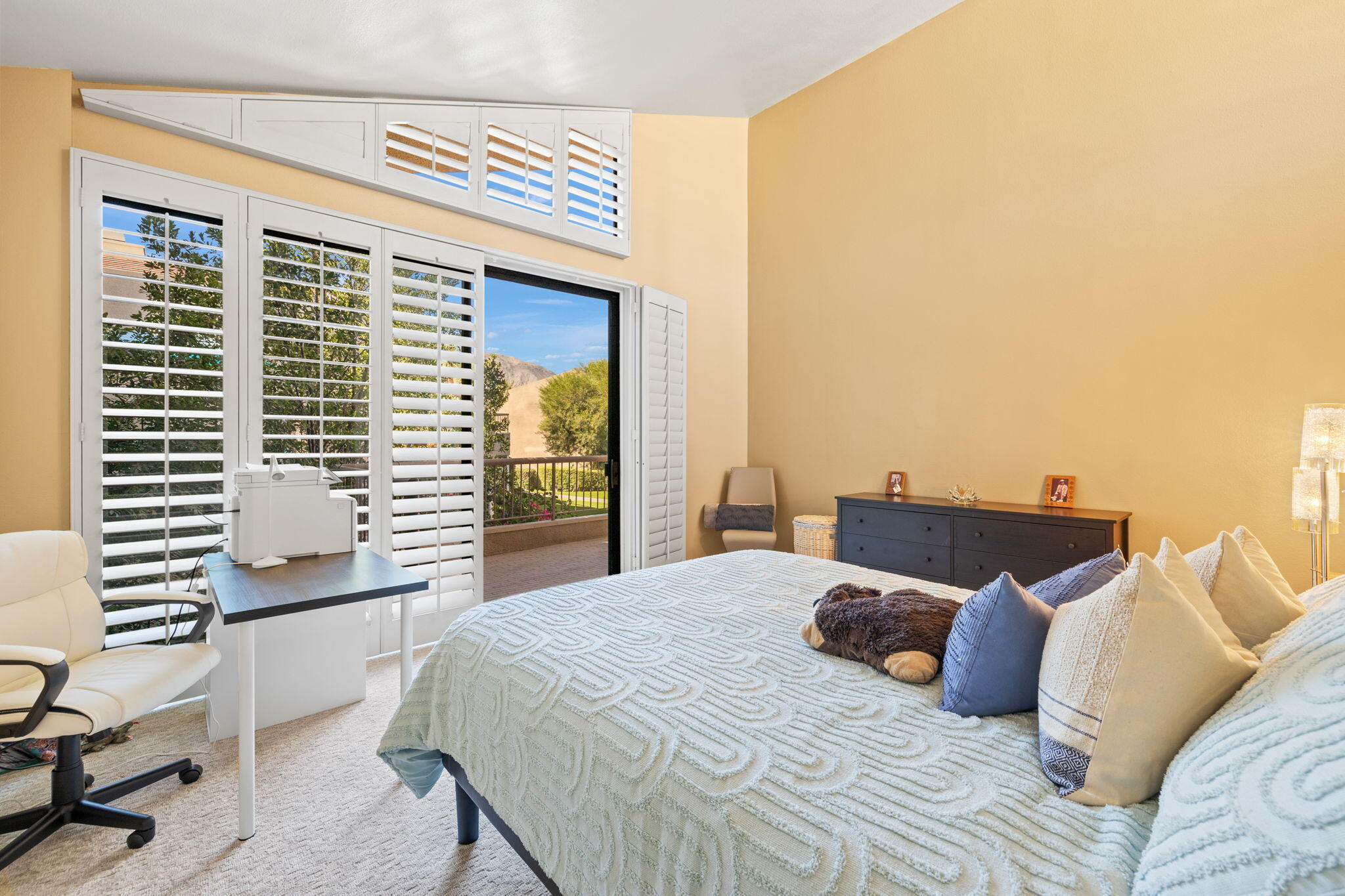 45775 Juniper Circle, Unit 616A Palm Desert, CA 92260 - Photo 18 of 35 a bedroom with a large bed and a balcony