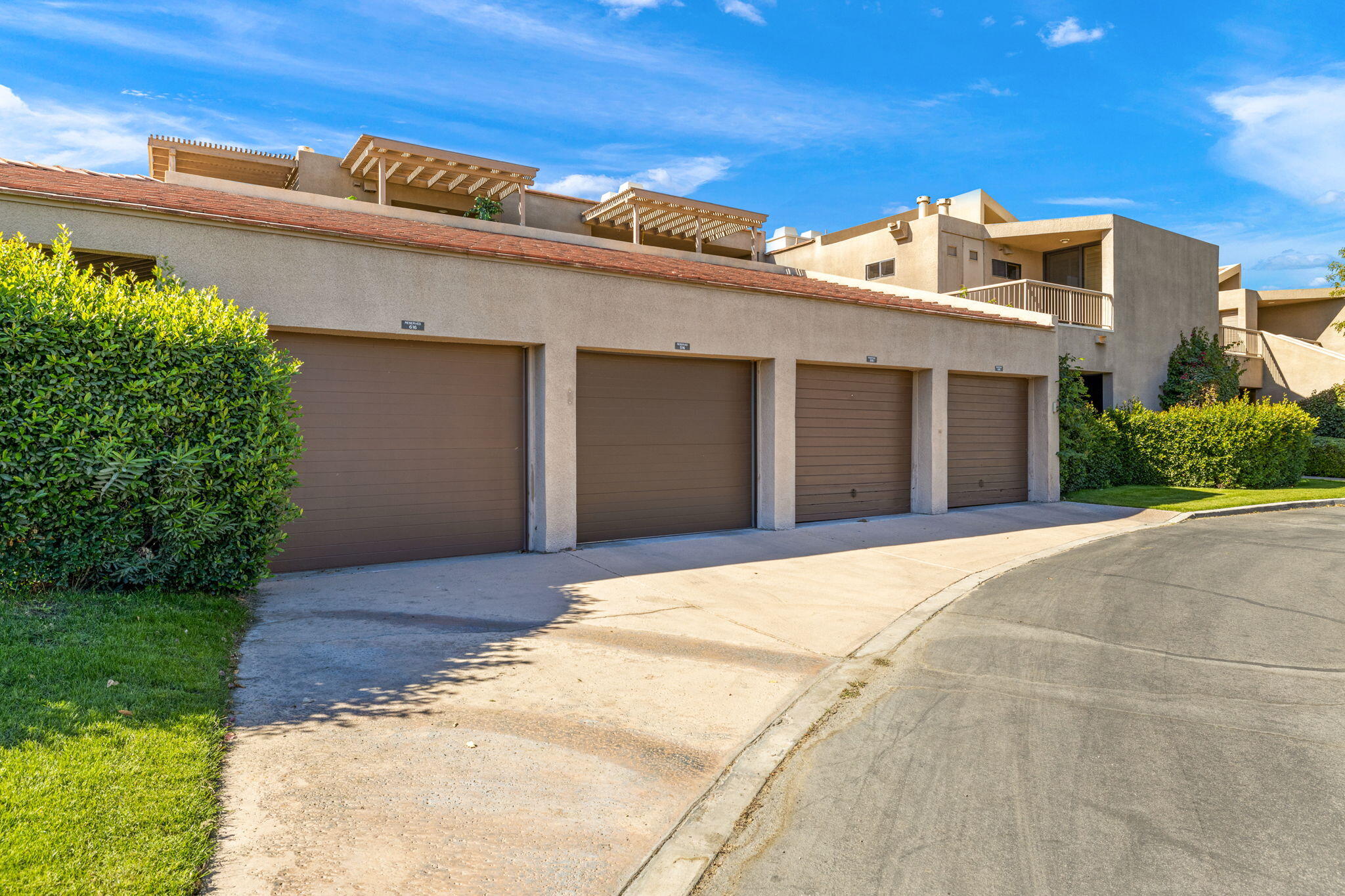 45775 Juniper Circle, Unit 616A Palm Desert, CA 92260 - Photo 29 of 35 a front view of a house with a garden