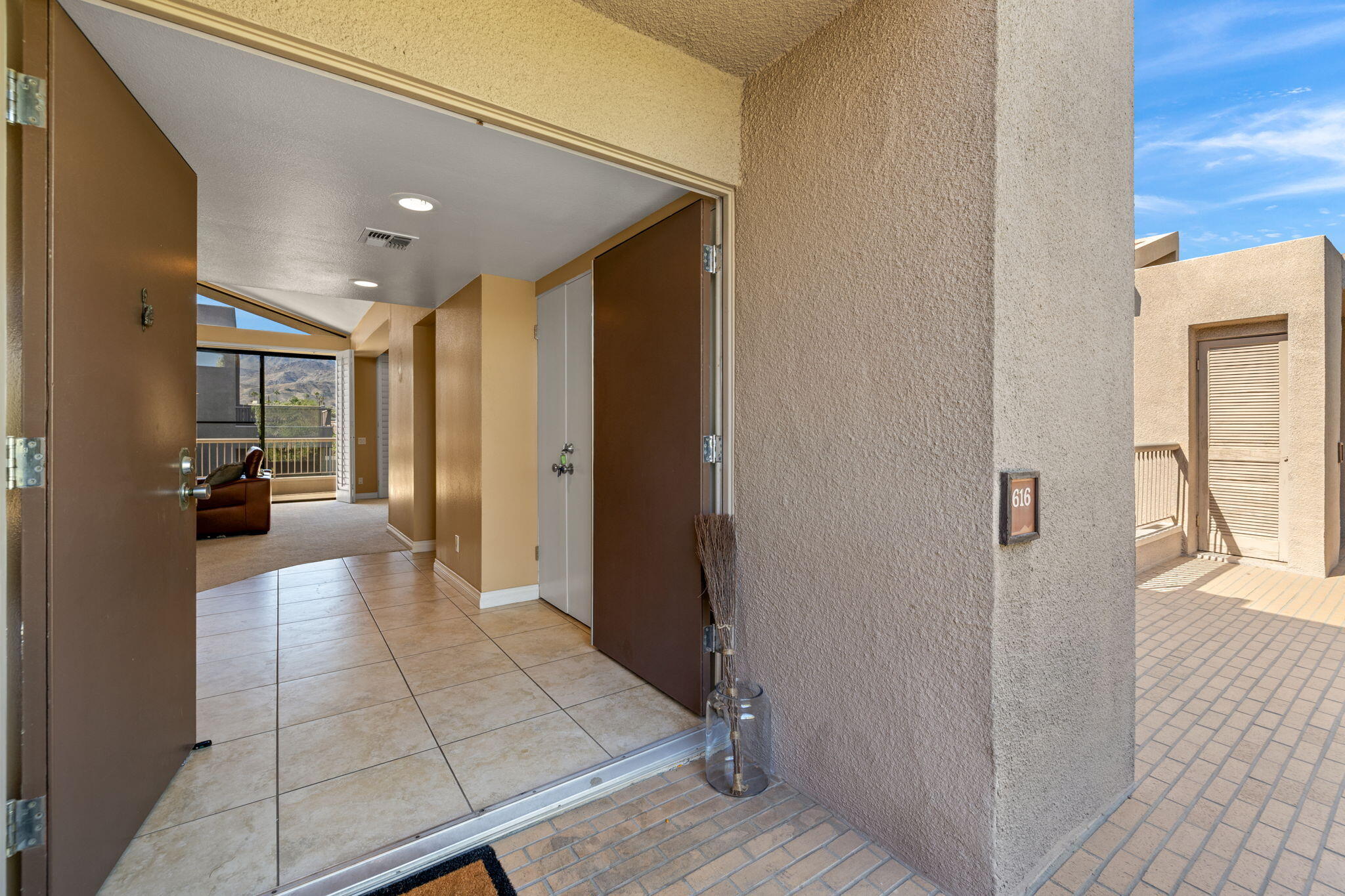 45775 Juniper Circle, Unit 616A Palm Desert, CA 92260 - Photo 30 of 35 a view of a hallway with a livingroom and a livingroom with furniture