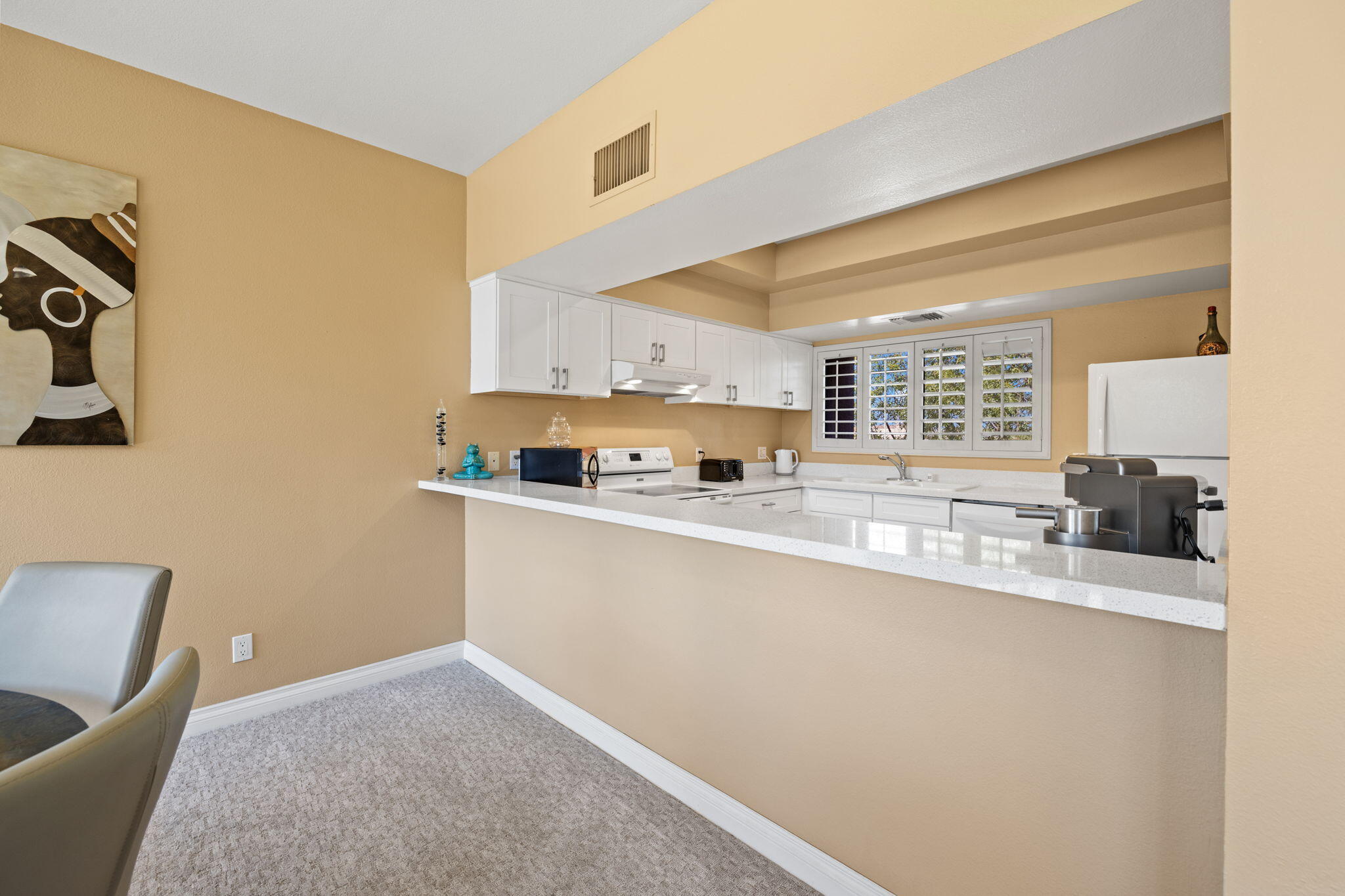 45775 Juniper Circle, Unit 616A Palm Desert, CA 92260 - Photo 8 of 35 a kitchen with stainless steel appliances granite countertop a sink and a refrigerator