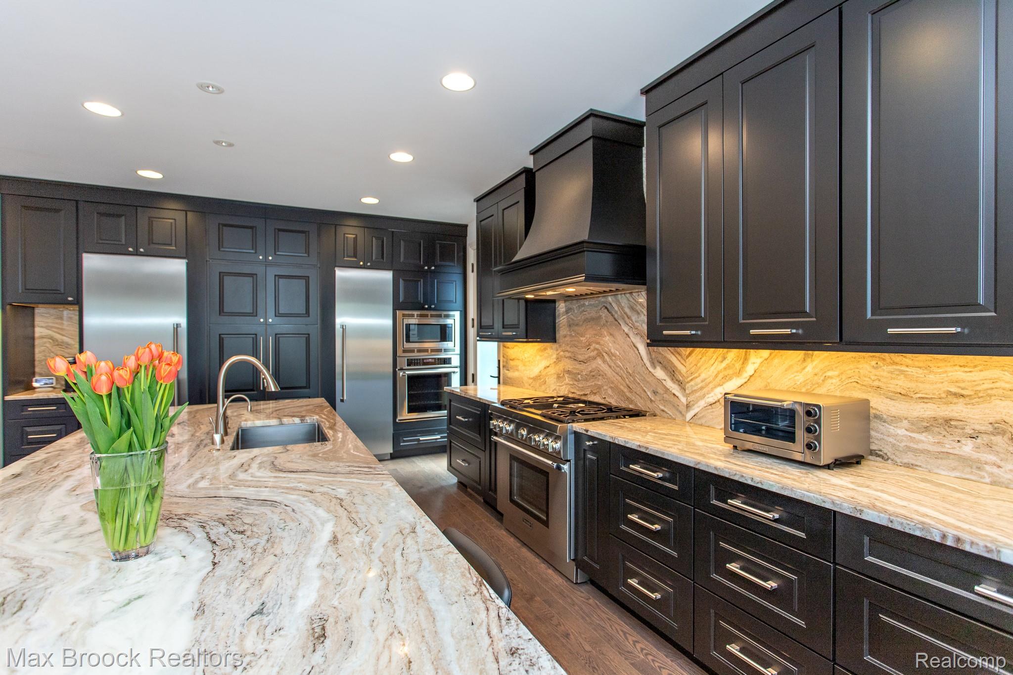 25925 York Road Royal Oak, MI 48067 - Photo 15 of 88 Kitchen featuring light stone countertops, built in appliances, recessed lighting, dark cabinets, and backsplash