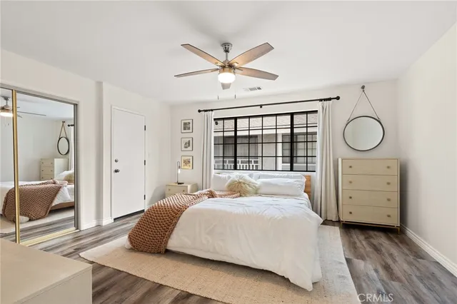 a bedroom that has a bed and a flat screen tv