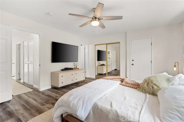 a bedroom with a bed and flat screen tv