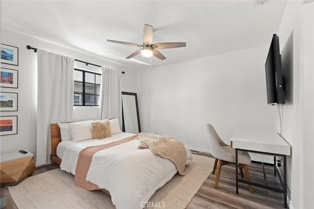 a bedroom with a bed and a flat screen tv