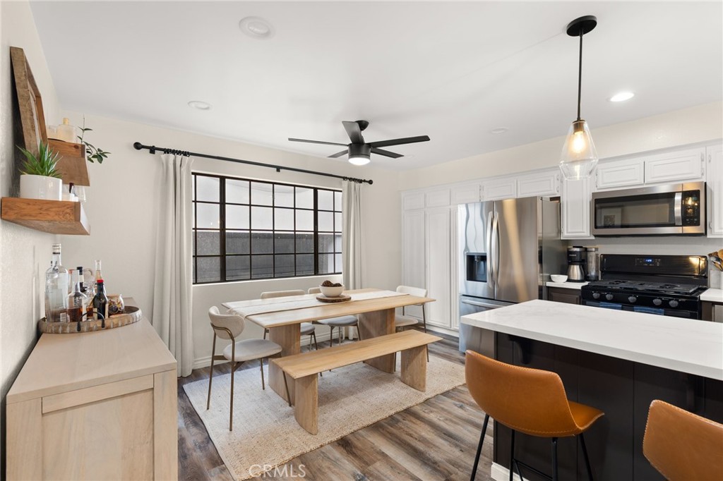 4345 154th Street, Unit 3 Lawndale, CA 90260 - Photo 9 of 31 a room with stainless steel appliances kitchen island granite countertop a dining table chairs and a refrigerator