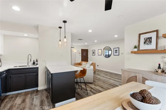a room with furniture a ceiling fan and a chandelier