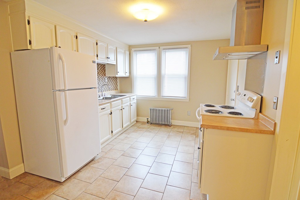 48-50 Jenness Street Springfield, MA 01104 - Photo 4 of 18 a kitchen with stainless steel appliances a refrigerator sink and cabinets