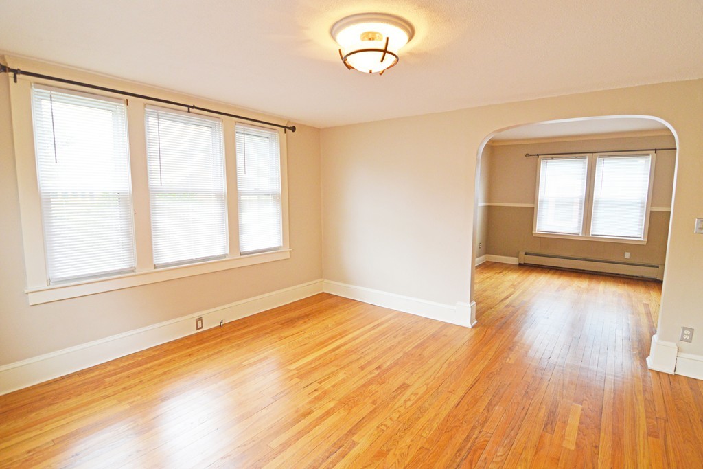 48-50 Jenness Street Springfield, MA 01104 - Photo 10 of 18 an empty room with wooden floor and windows