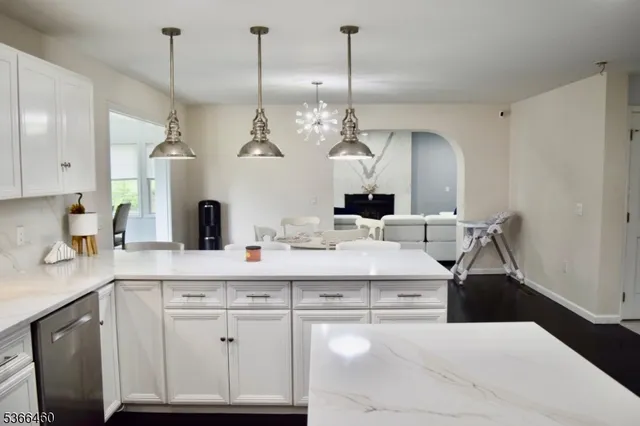 a kitchen with white cabinets and sink