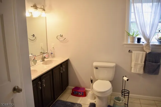 a bathroom with a sink toilet and a mirror