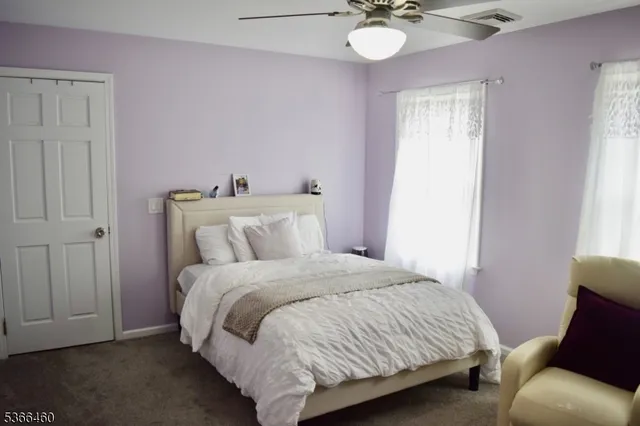 a bedroom with a bed and chandelier