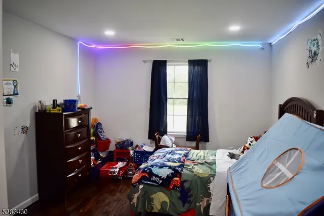 a bedroom with furniture and a window