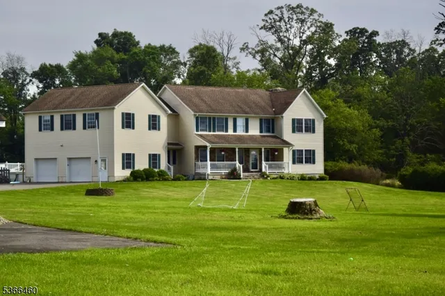 a front view of a house with a yard table and chairs