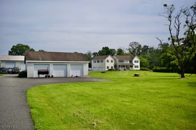 a view of house that has a big yard