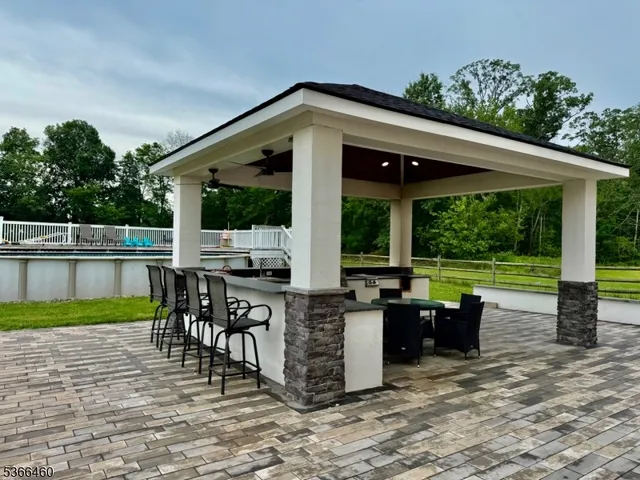 a front view of a house with garden and patio