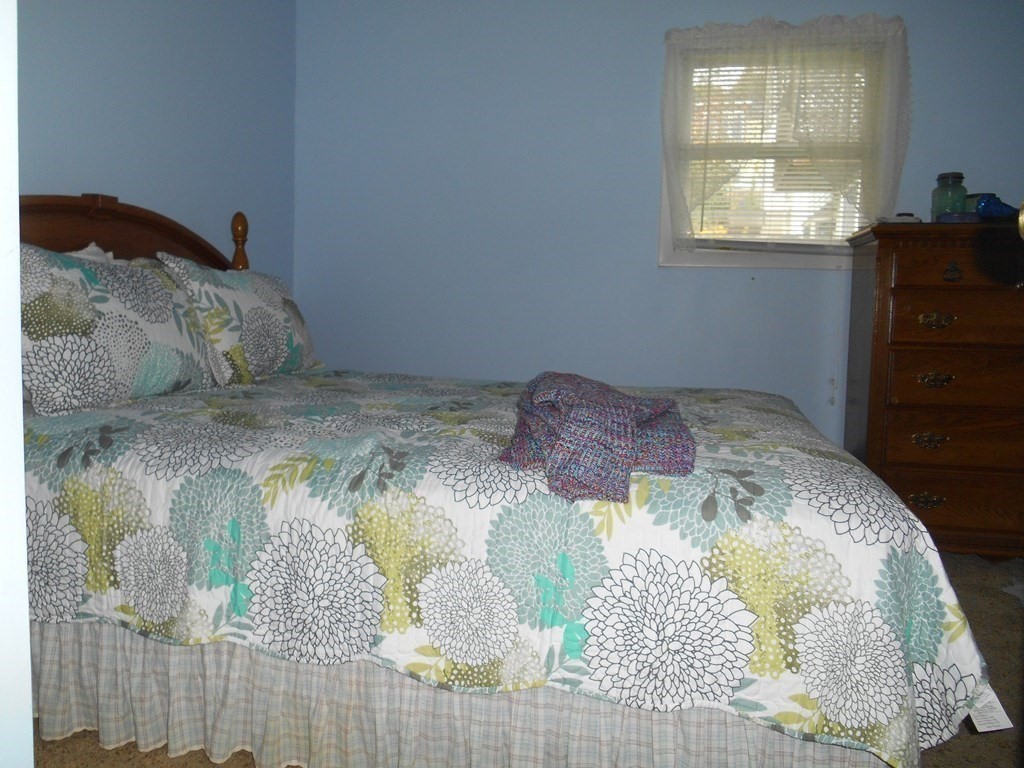190 Dominion Road Worcester, MA 01605 - Photo 11 of 13 a bed with a blanket and pillows