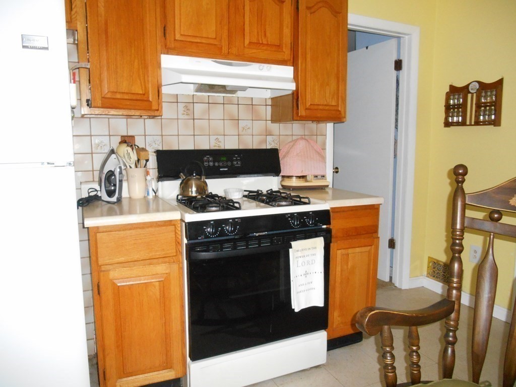 190 Dominion Road Worcester, MA 01605 - Photo 9 of 13 a kitchen with stainless steel appliances granite countertop a stove a sink and a microwave