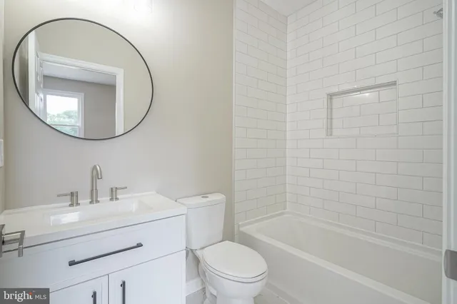 a bathroom with a sink toilet and a mirror