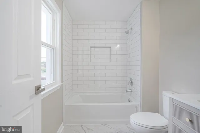 a bathroom with a toilet and a bathtub