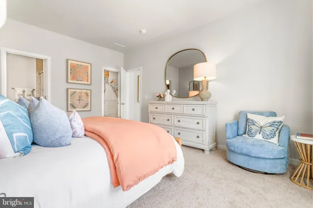 a bathroom with a granite countertop sink mirror vanity and a toilet