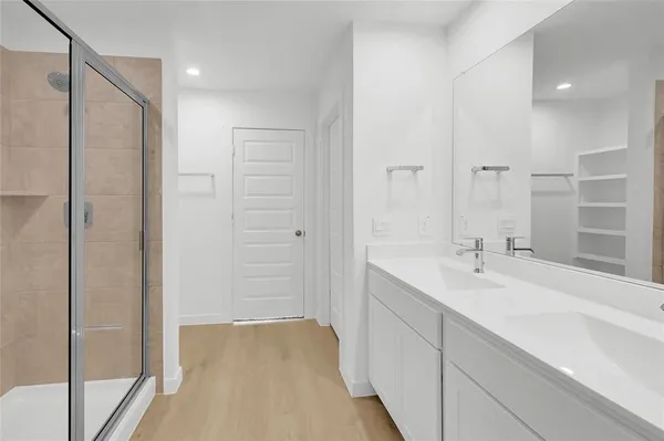 a bathroom with a shower and a sink