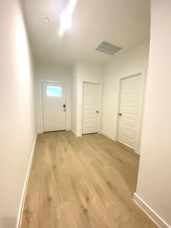 a view of a hallway with wooden floor