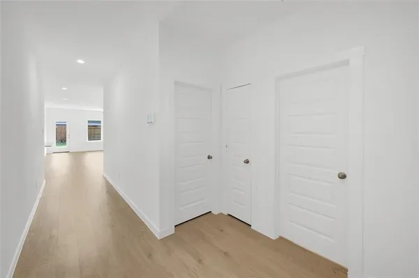 an empty room with fan and windows