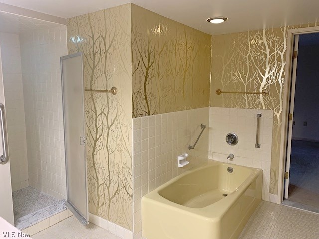 2385 Covington Road, Unit 302 Akron, OH 44313 - Photo 13 of 19 Bathroom featuring tile walls, tile floors, and plus walk in shower