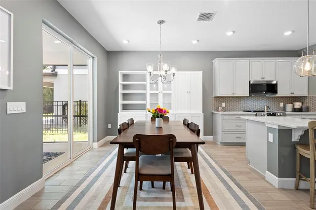 a living room with furniture a rug and a chandelier
