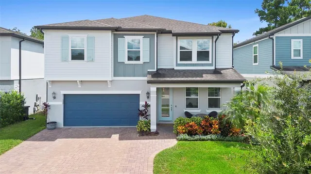 a front view of a house with a garden and plants