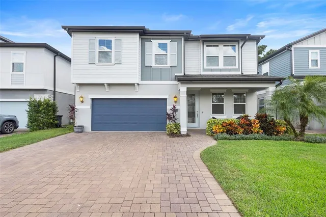 a front view of a house with a garden and yard