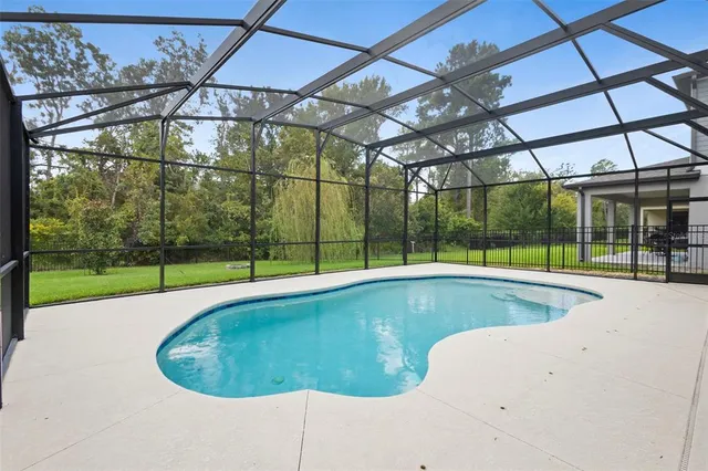 an aerial view of a house with a big yard
