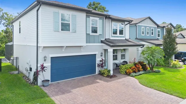 an aerial view of a house with a swimming pool