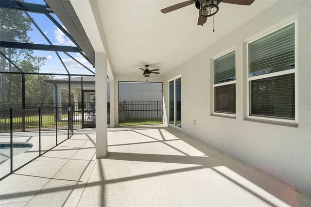 a view of swimming pool with outdoor seating and a palm tree