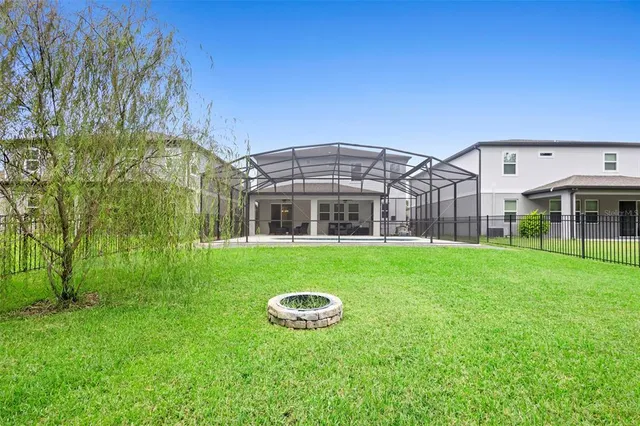 a front view of a house with a yard and potted plants