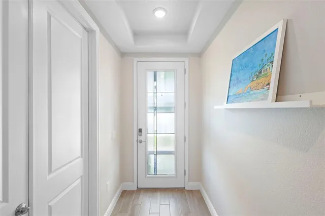 a view of a dining room with furniture a rug and wooden floor