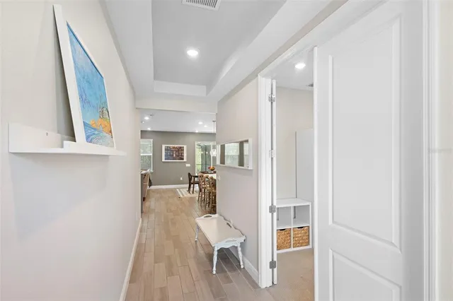 a kitchen with stainless steel appliances a stove a sink a refrigerator a center island a table and chairs