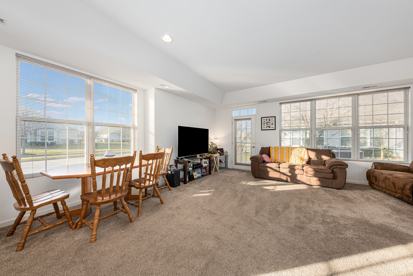 13512 Delaney Road Huntley, IL 60142 - Photo 2 of 24 a living room with furniture and a flat screen tv