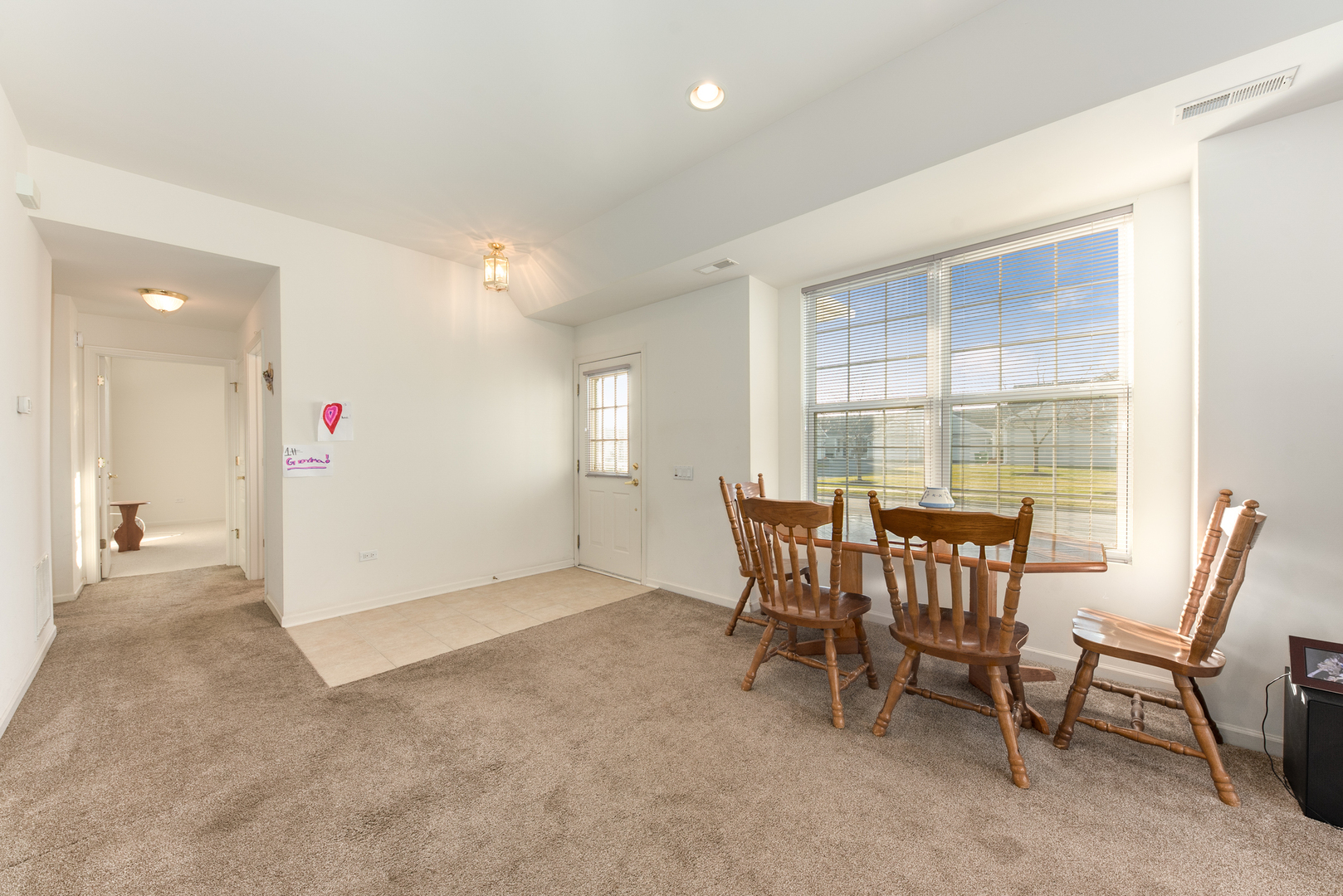 13512 Delaney Road Huntley, IL 60142 - Photo 5 of 24 a view of a dining room with furniture and window