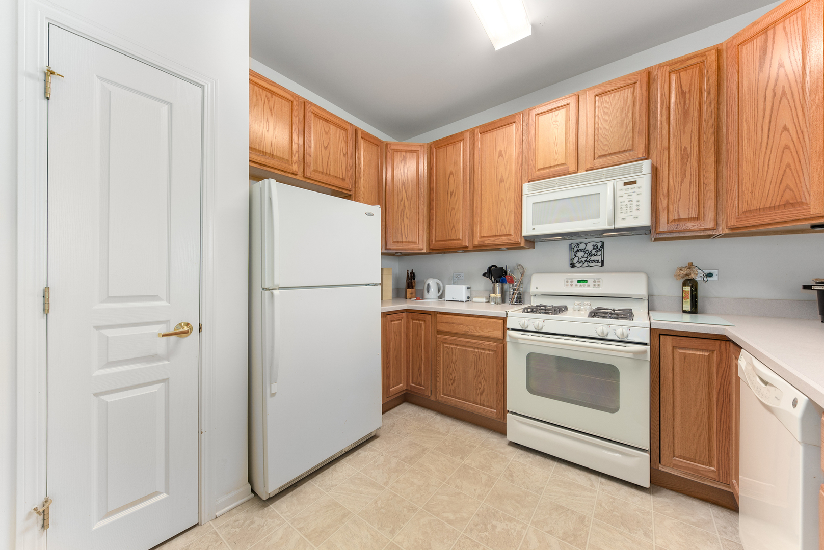 13512 Delaney Road Huntley, IL 60142 - Photo 7 of 24 a kitchen with cabinets stainless steel appliances and window