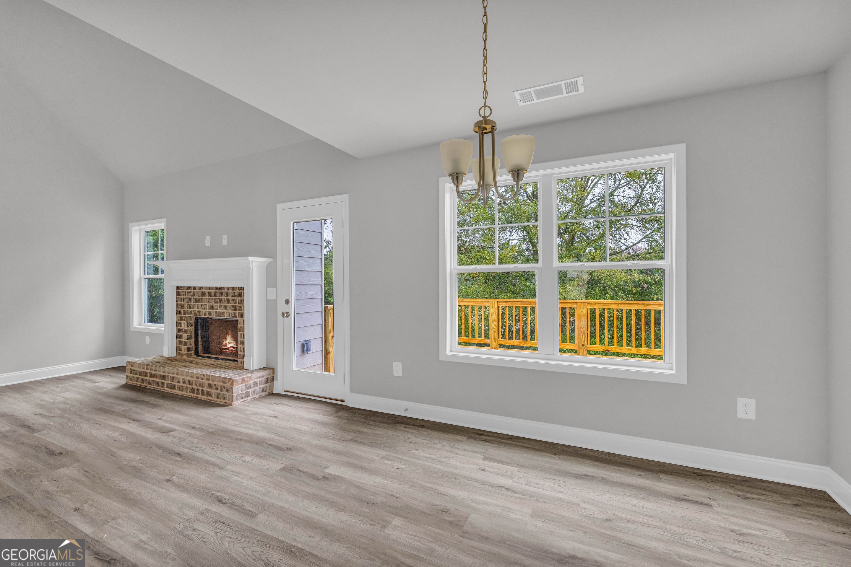 152 Sewell Road Lavonia, GA 30553 - Photo 13 of 60 a view of an empty room with wooden floor fireplace and a window